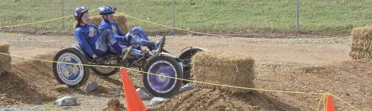 NASA Rover Challenge - two students pedalling a four-wheel rover